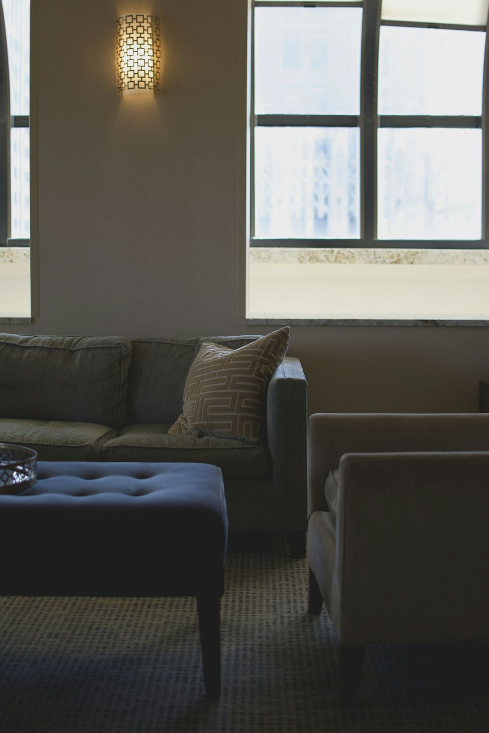 brown couch beside white wall