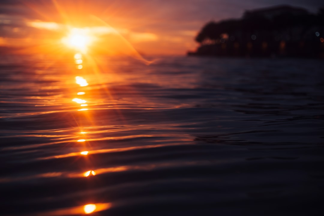 body of water during sunset