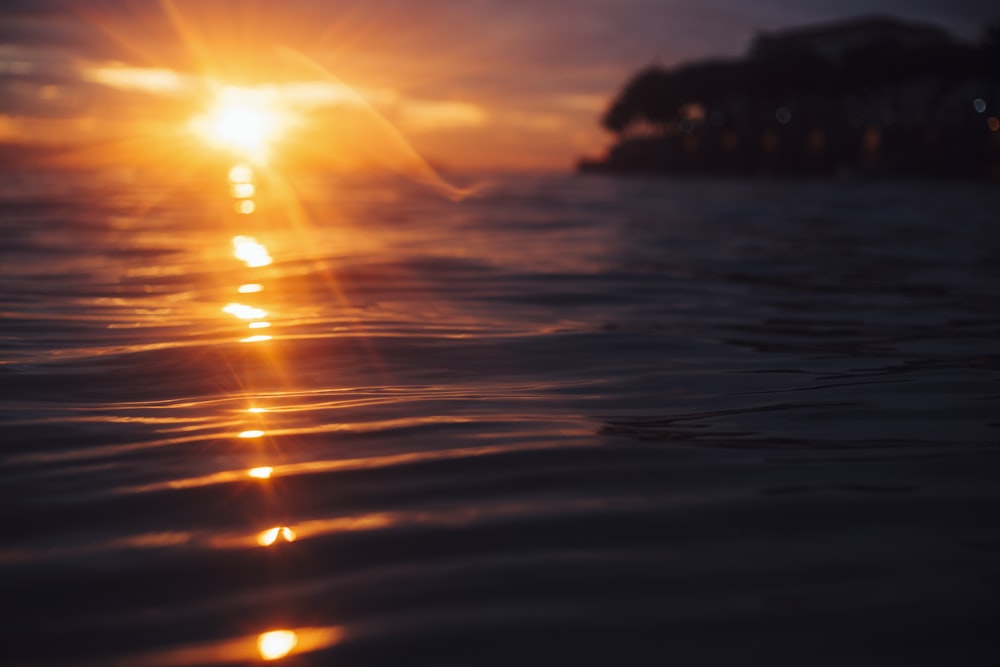 body of water during sunset