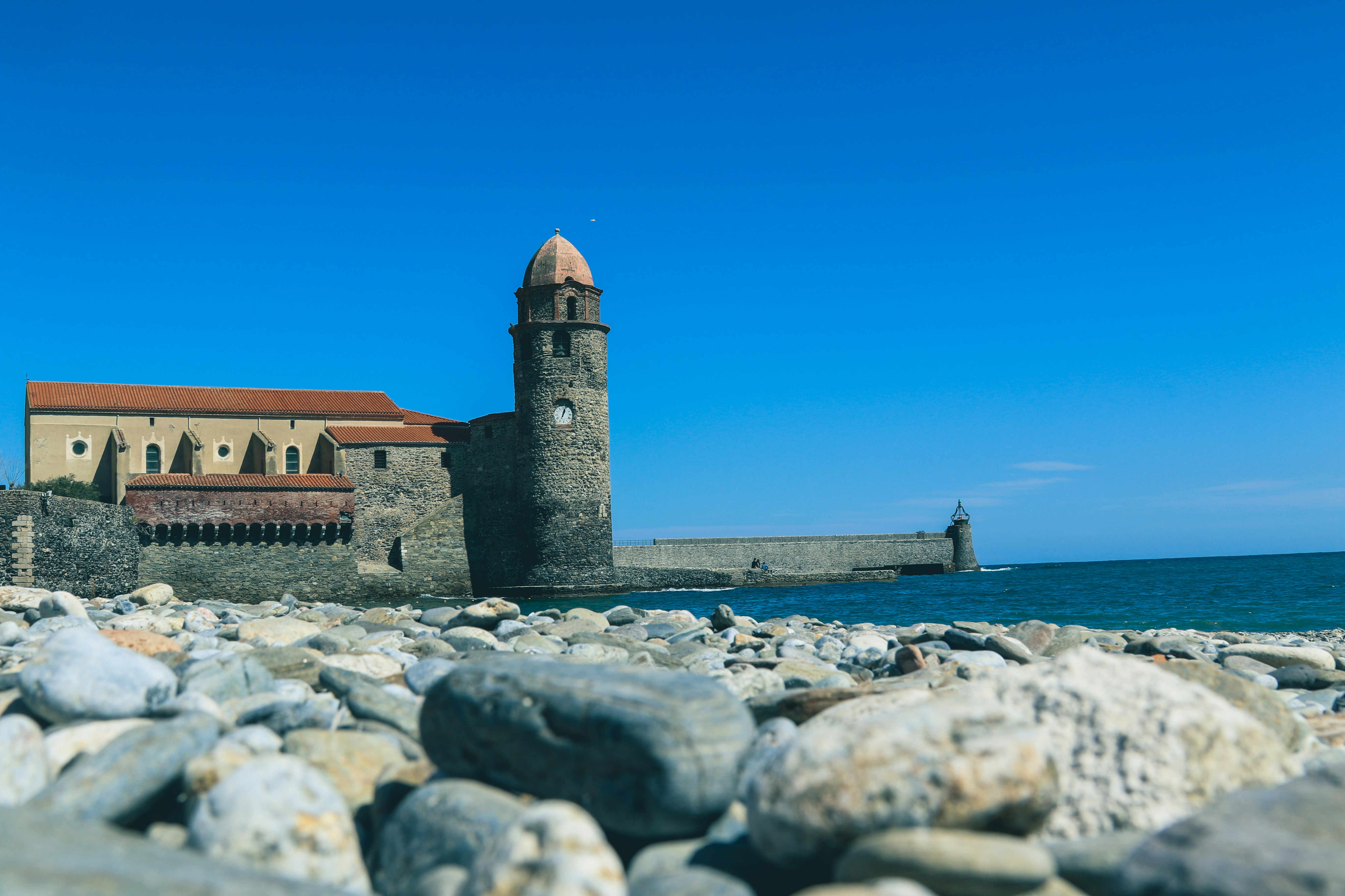 brown concrete building near sea during daytime, 