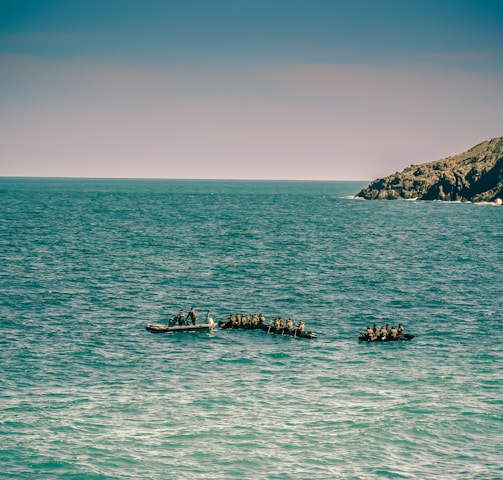 people on boat on sea during daytime