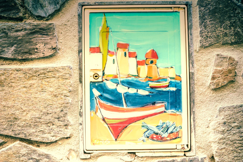 A vibrant mural depicting the sea and local fishermen, painted on the exterior wall of Le Gibraltar.