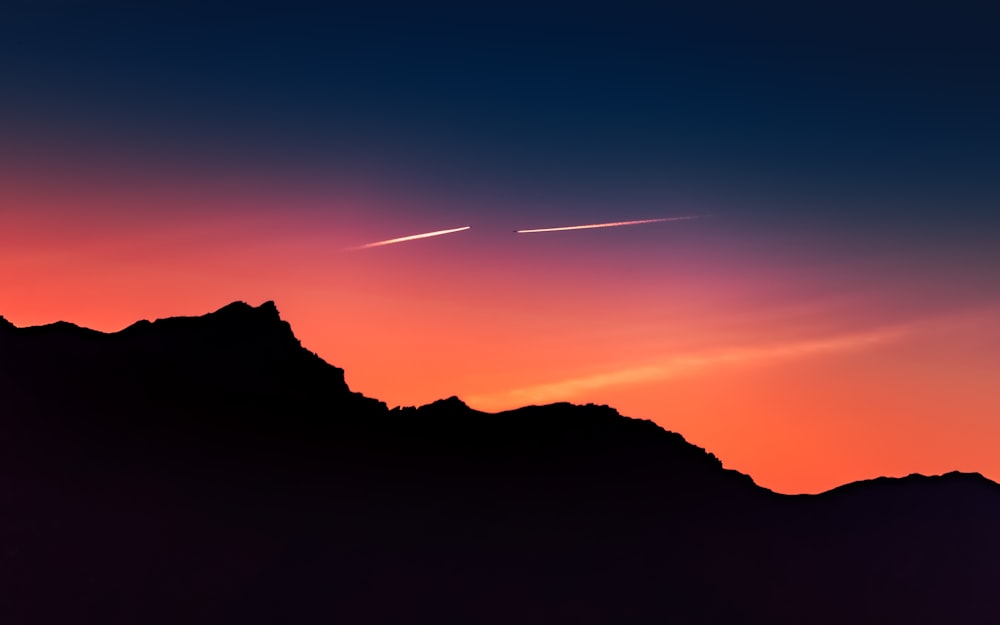 silhouette of mountain during sunset