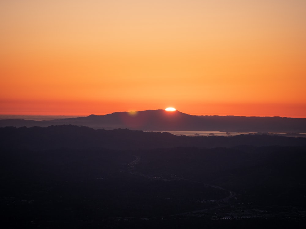 silhouette of mountain during sunset