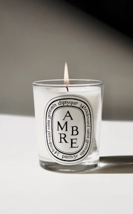 Close-up of a candle featuring a horse silhouette on its label.
