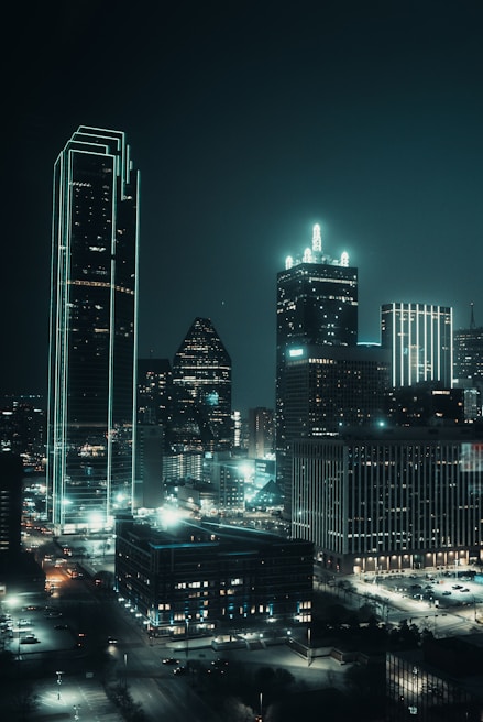 A surreal cityscape at night, glowing with neon lights and futuristic architectural forms.