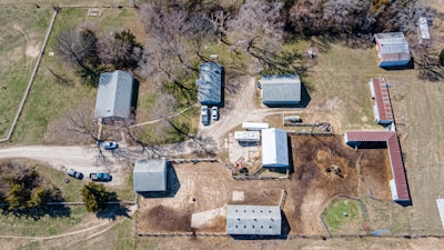 Aerial view of a farm with construction equipment and structures.