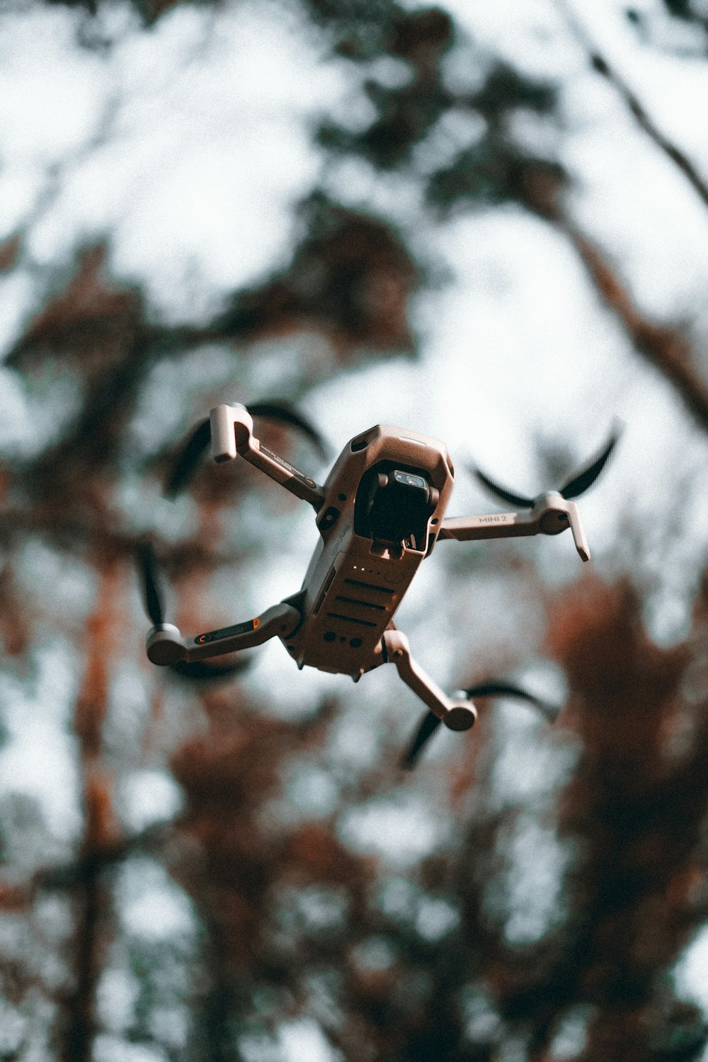 brown and black drone in mid air