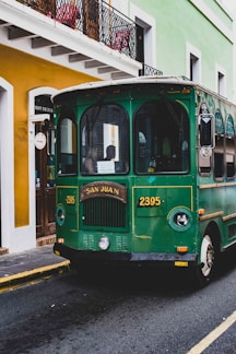 green and white bus on road during daytime