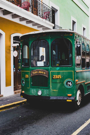 green and white bus on road during daytime