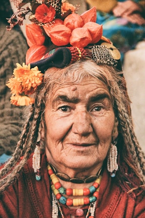 An elderly person sharing wisdom with younger generations.