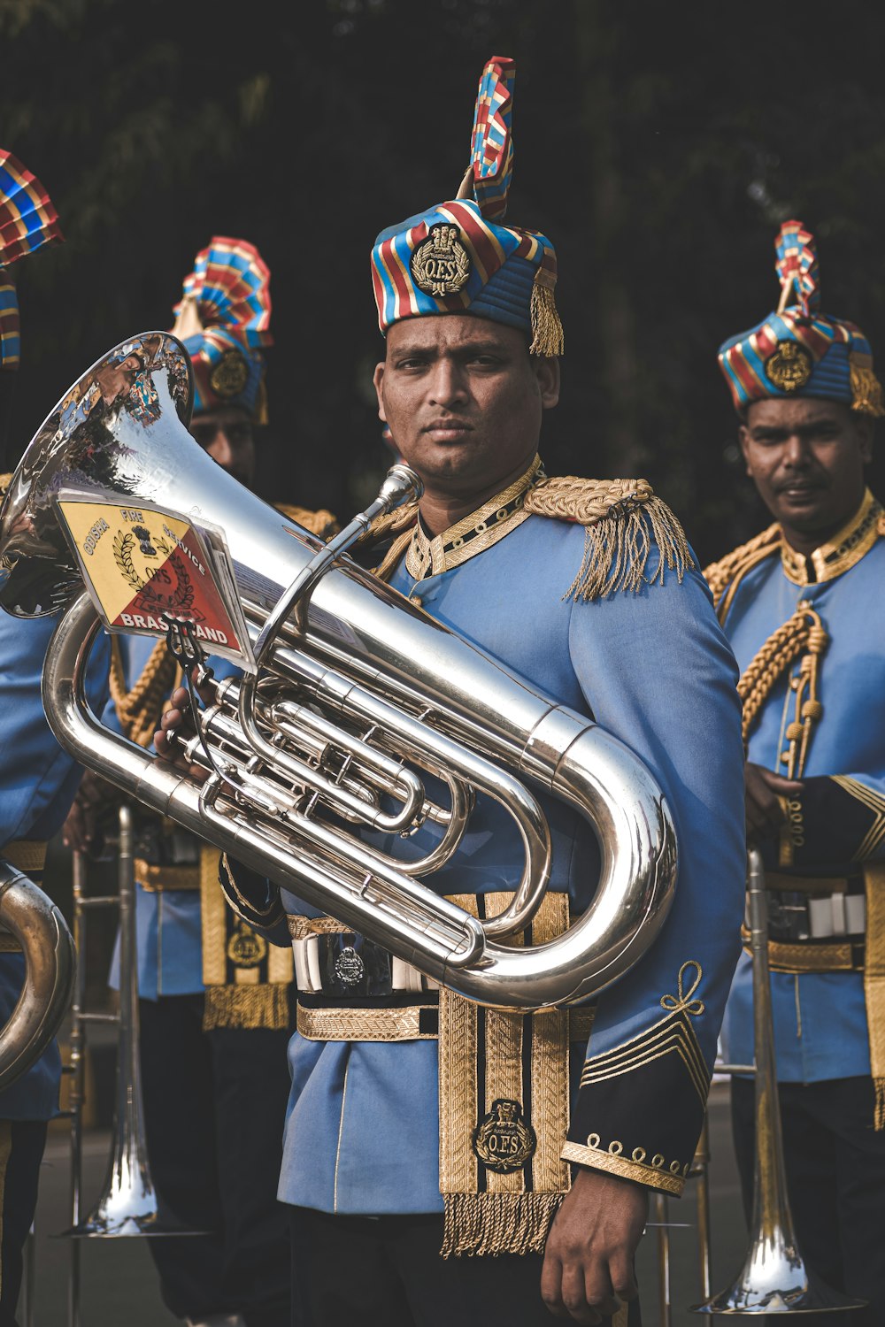 man in gold and blue hat playing trumpet