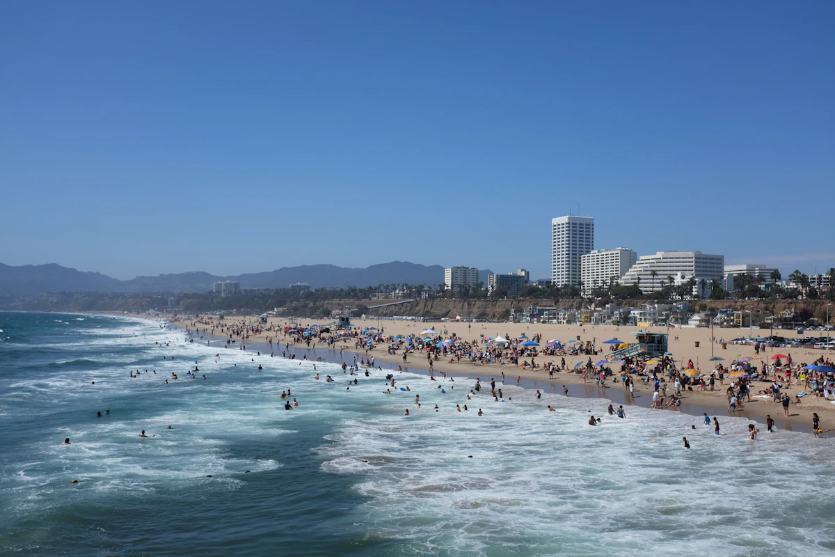 Swimmers and beachgoers beside the Pacific at Santa Monica