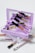 A collection of makeup items arranged around a light purple mirrored makeup palette. Various lip glosses and eyeliner tubes are displayed, with some featuring glitter and metallic designs. The open palette reflects multiple makeup products inside, creating a visually layered effect.