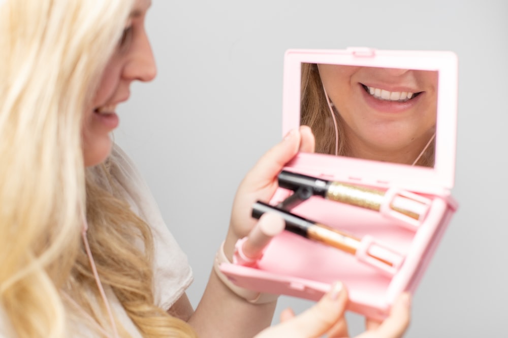 woman holding white and pink box