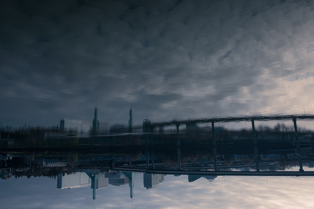 black metal bridge under gray clouds