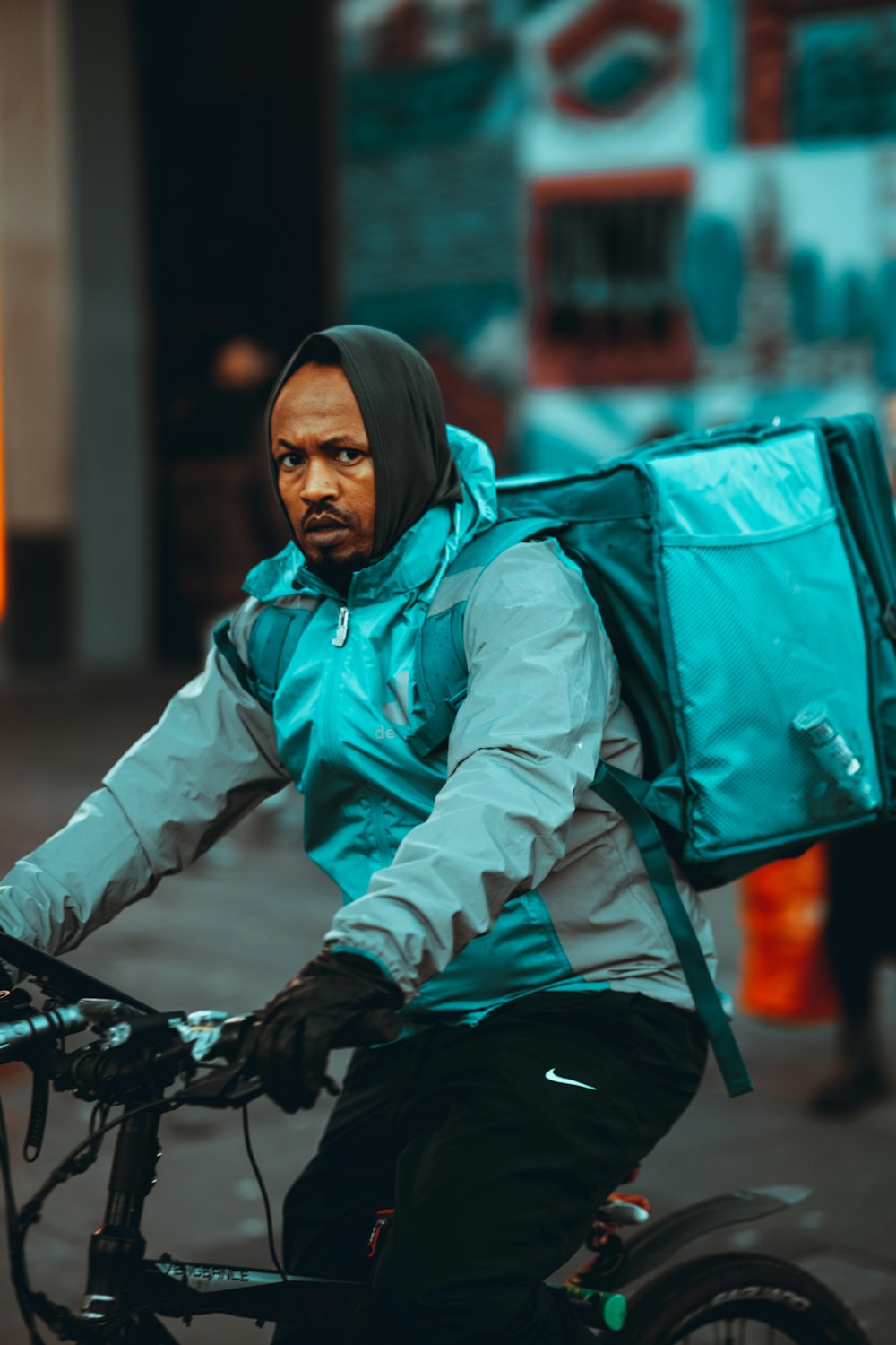 woman in white jacket and black pants sitting on bicycle