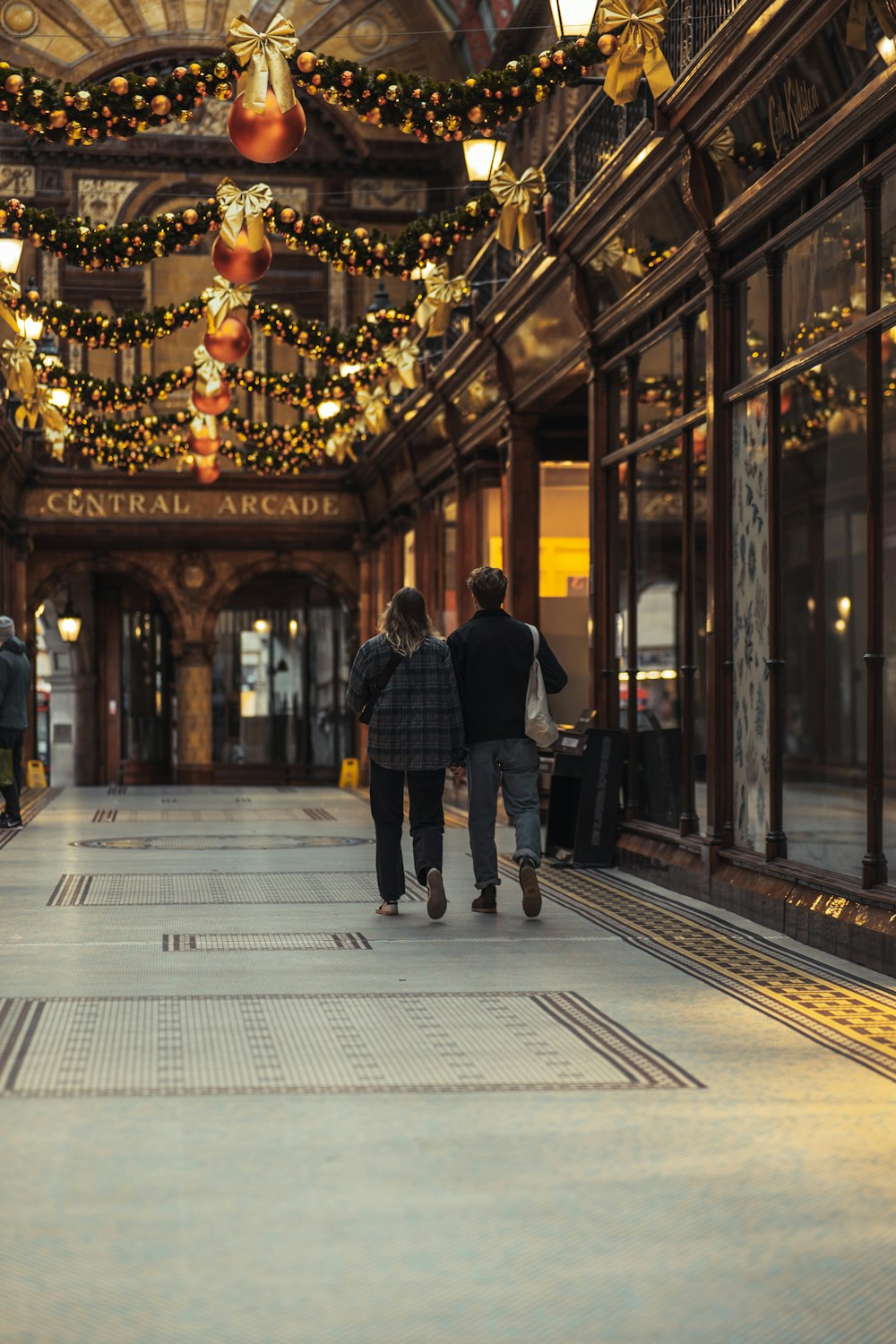 man in black jacket walking on sidewalk during nighttime