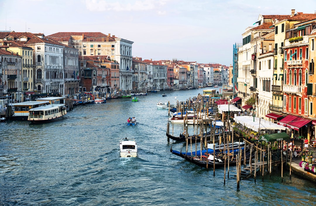 boat on water between buildings during daytime