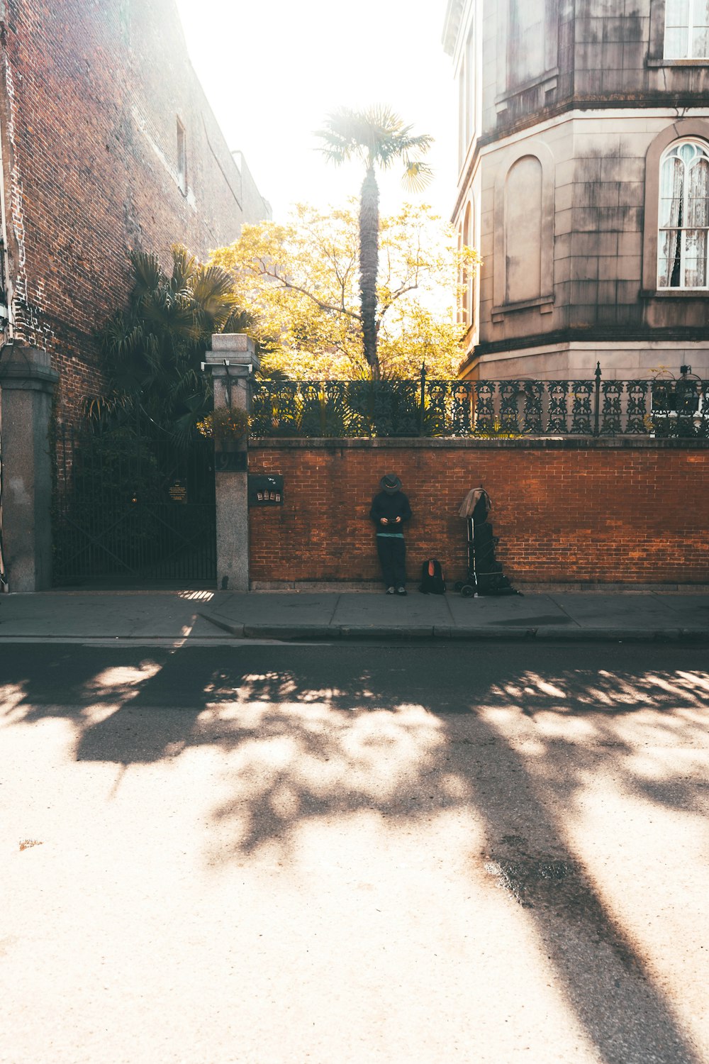 man in black jacket standing on gray concrete pathway during daytime