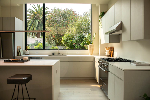 A bright, modern kitchen renovation featuring sleek cabinetry and integrated smart lighting.
