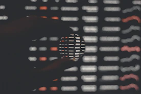 person holding black and white round ornament