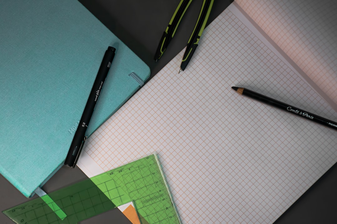 black click pen beside green paper