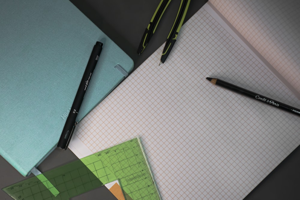 black click pen beside green paper