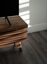 brown wooden table on gray floor