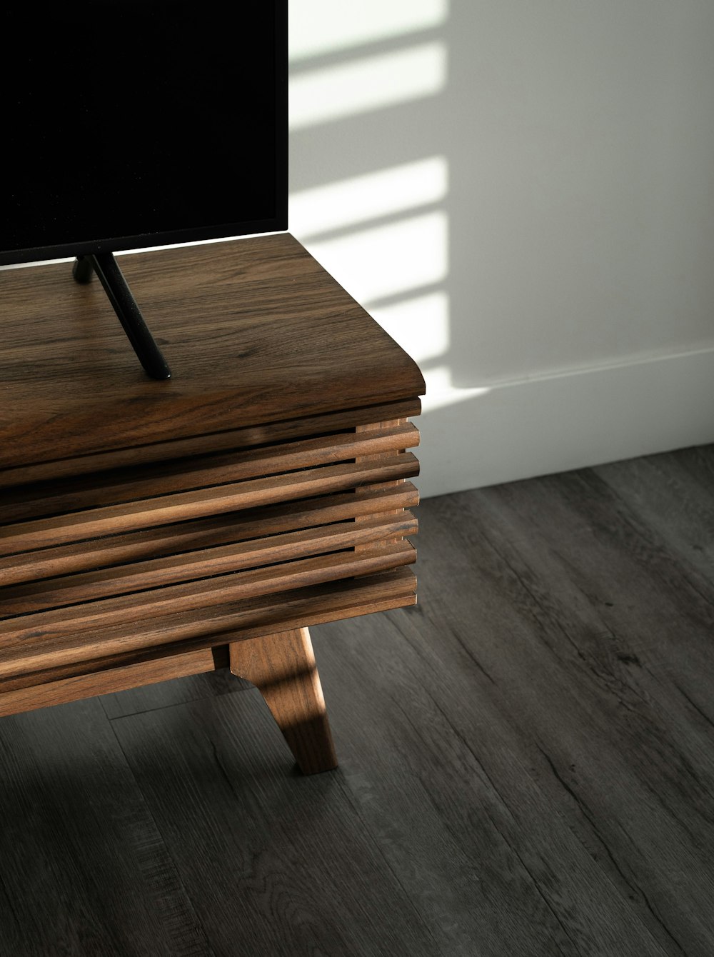 brown wooden table on gray floor