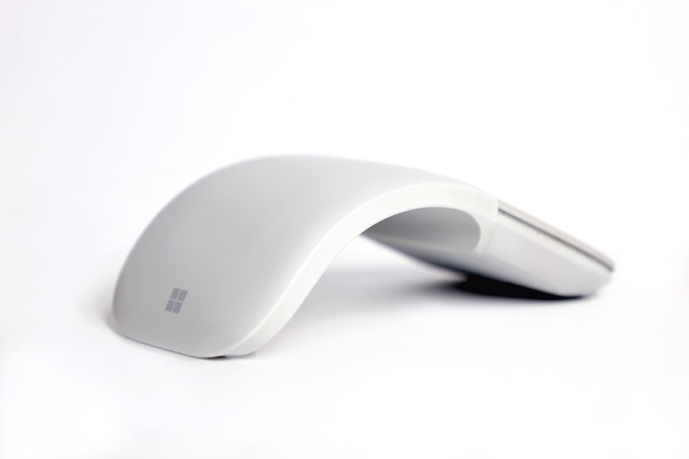 black apple magic mouse on white surface