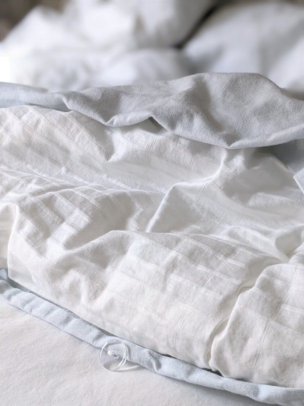 White and gray striped percale textile for patterned bedding