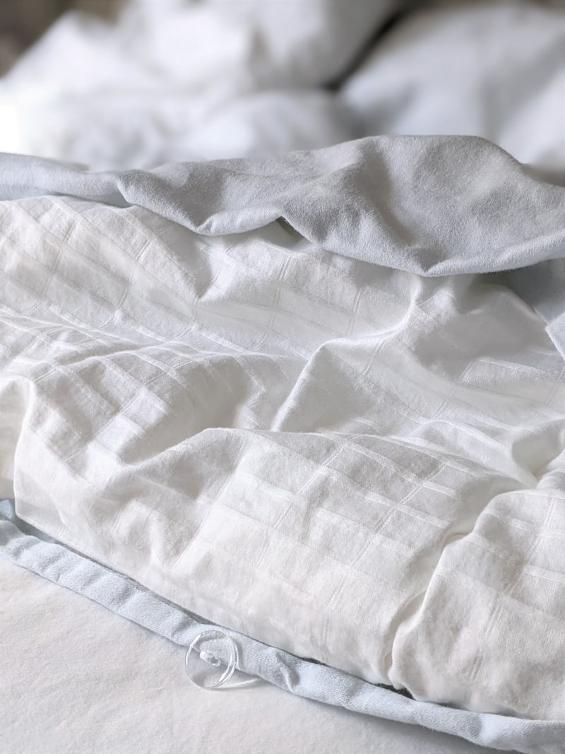 White and gray striped percale weave textile showing thread pattern detail