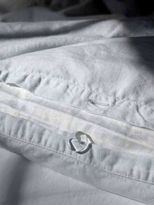 Gray percale weave textile showing tight one-over-one thread pattern