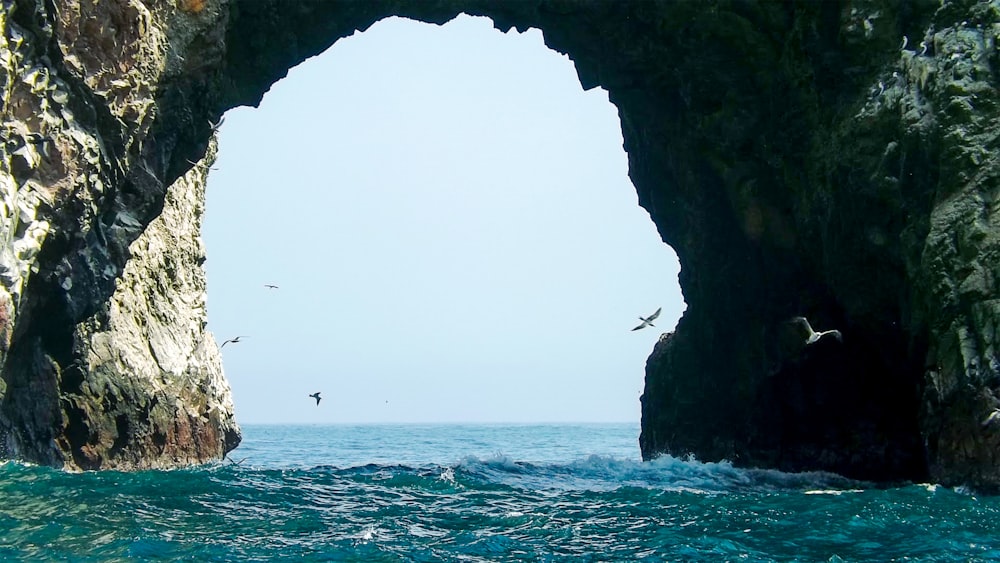 brown rock formation on sea during daytime