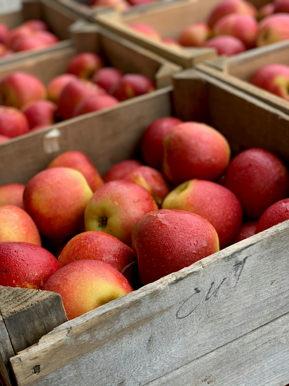 red apples on brown wooden crate