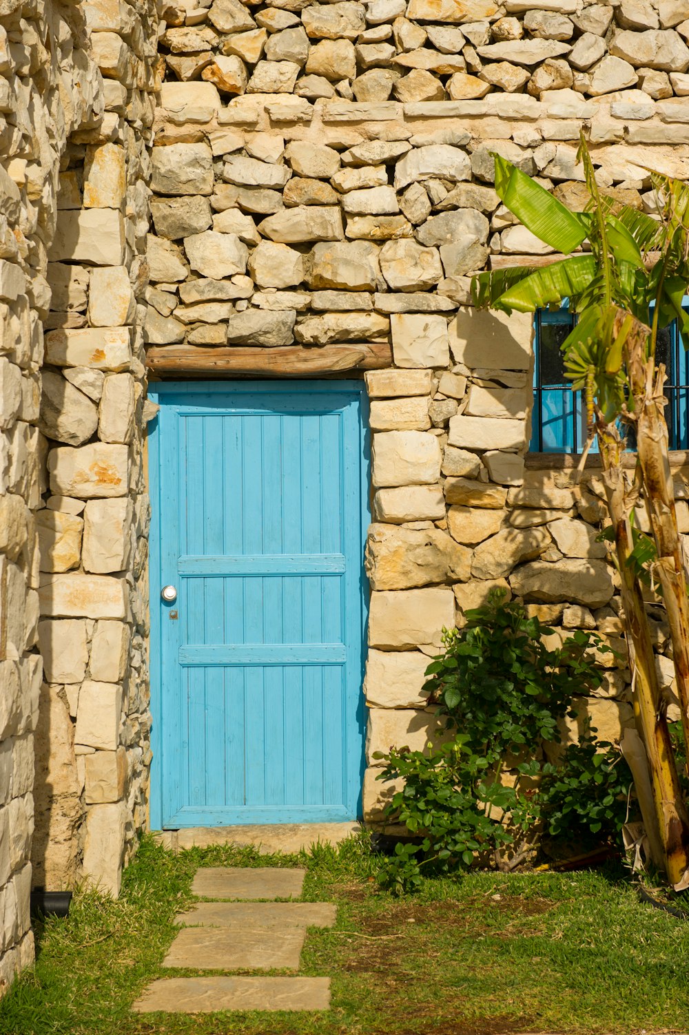 blue wooden door on gray concrete wall