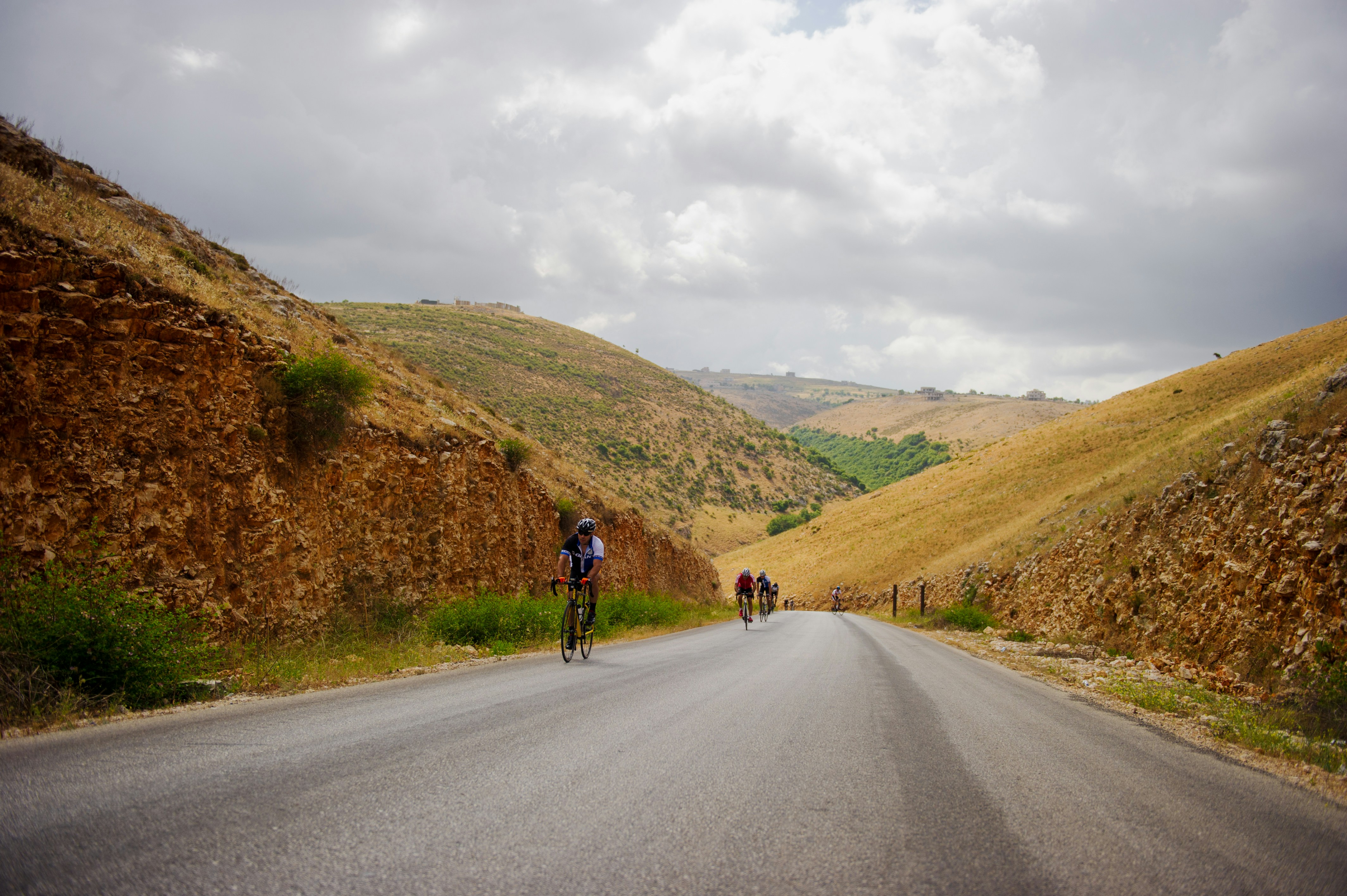 man in black jacket and black pants walking on road during daytime
