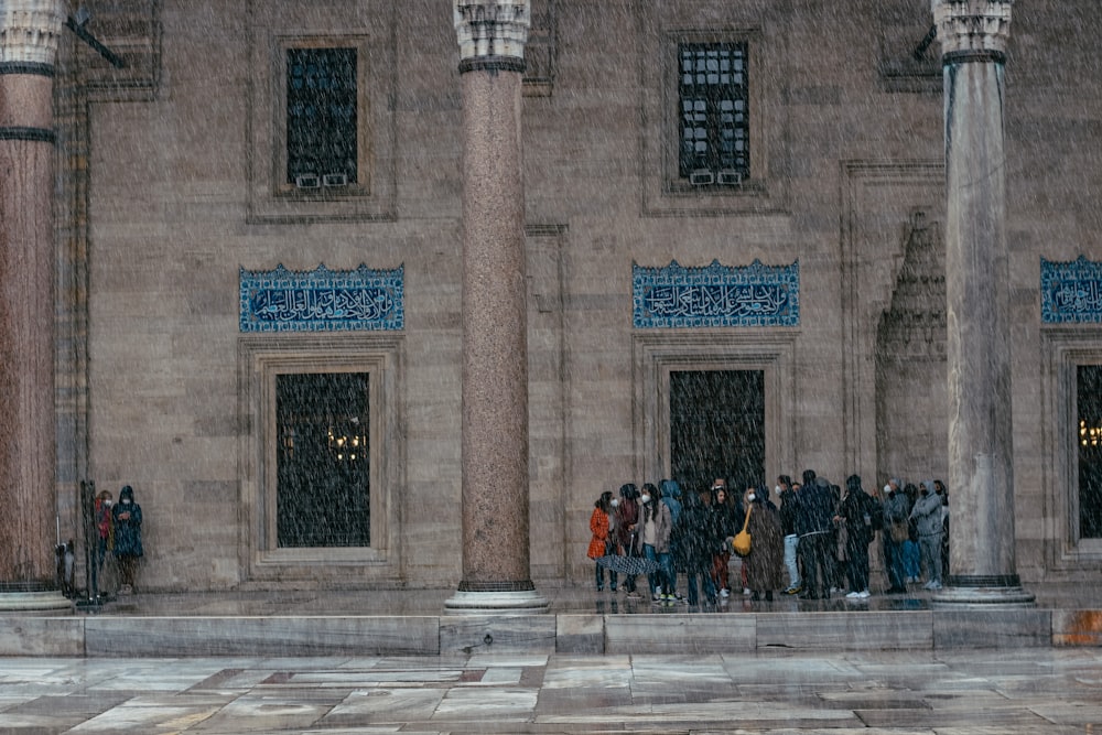 people sitting on bench near building during daytime