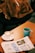 A cozy hoodie displayed on a wooden table with a soft blanket and a cup of coffee beside it.