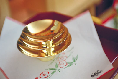 Elegant set of warm beige bagasse bowls arranged on a deep olive linen cloth.