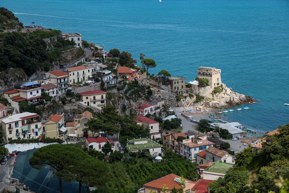 aerial view of city buildings near body of water during daytime