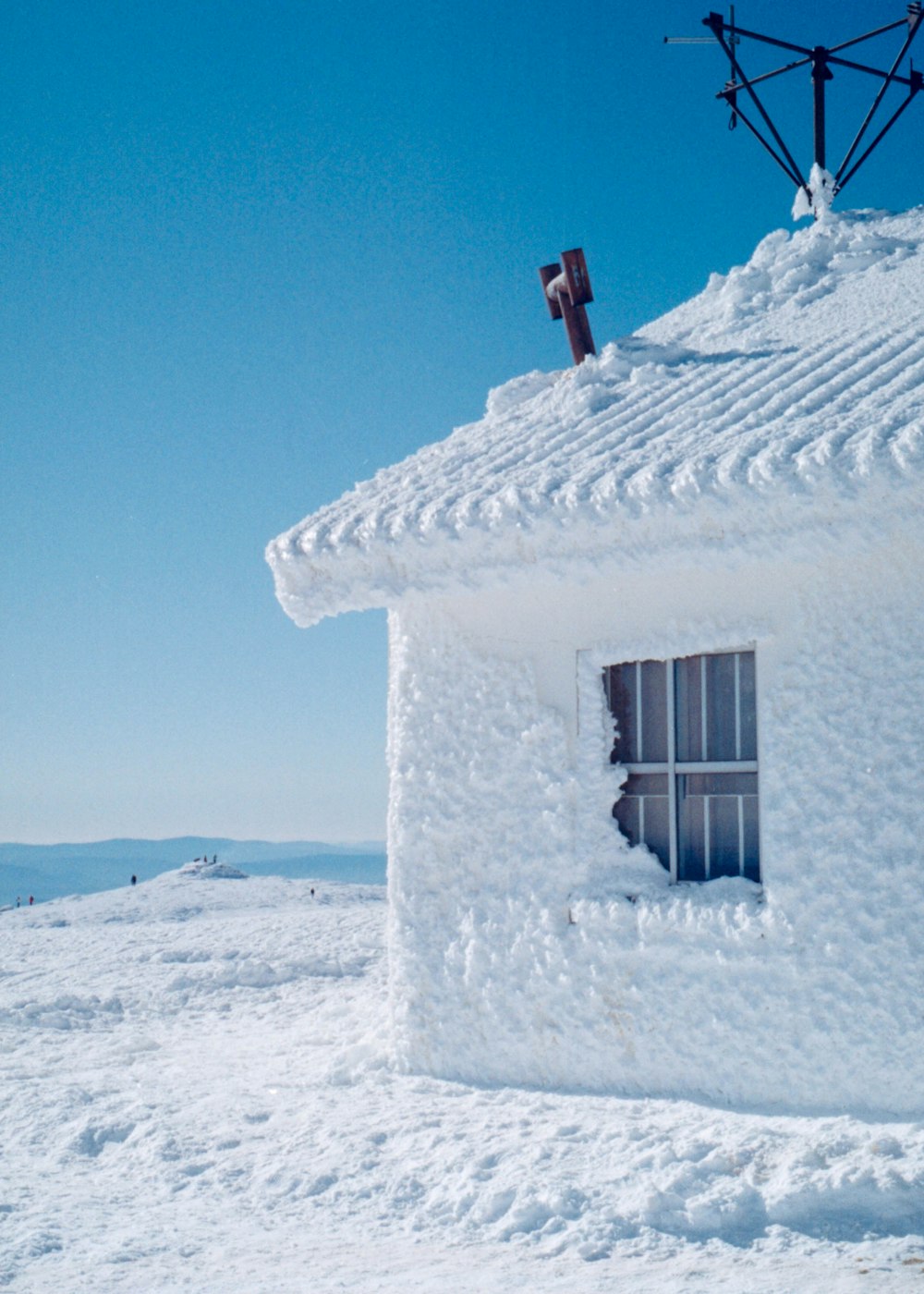 white concrete house on white sand during daytime