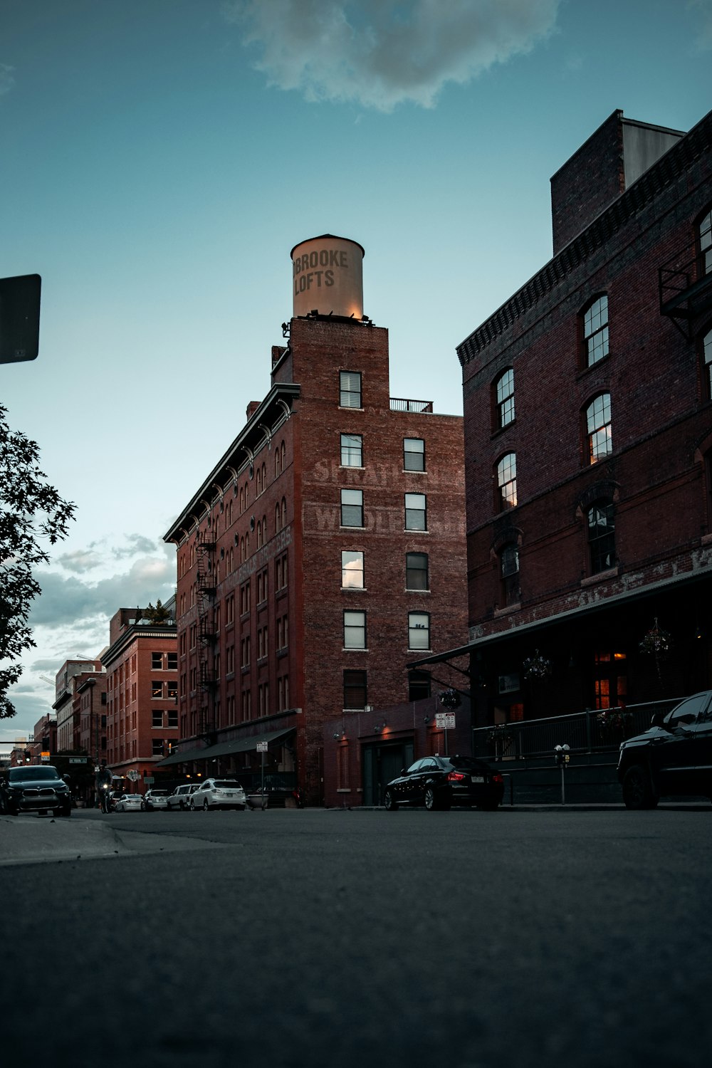 cars parked beside brown concrete building during daytime