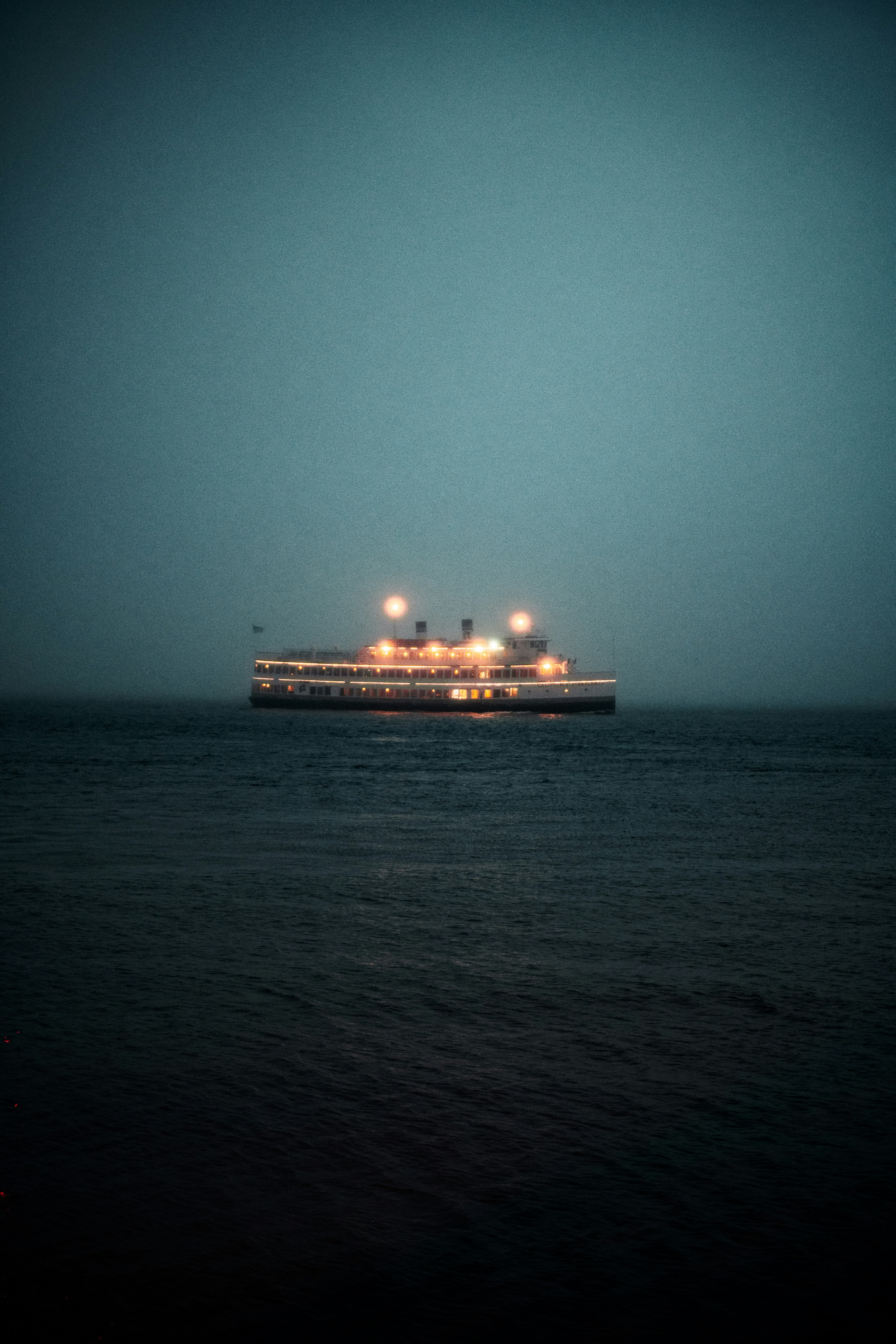 white cruise ship on sea during night time