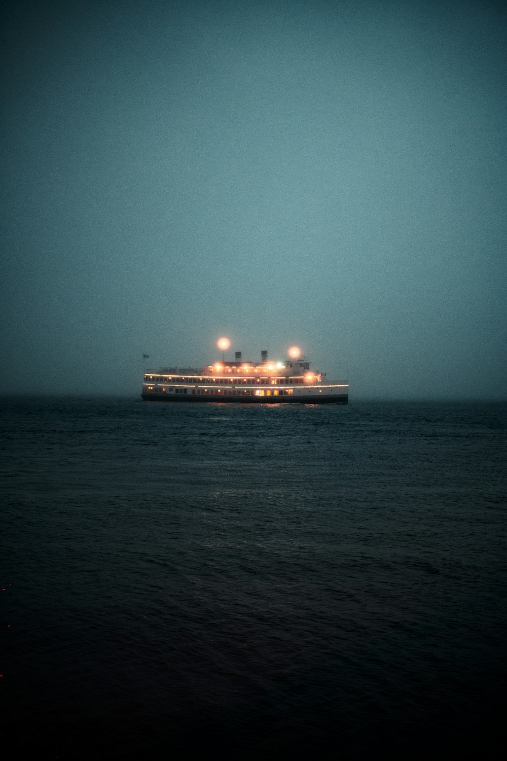 white cruise ship on sea during night time