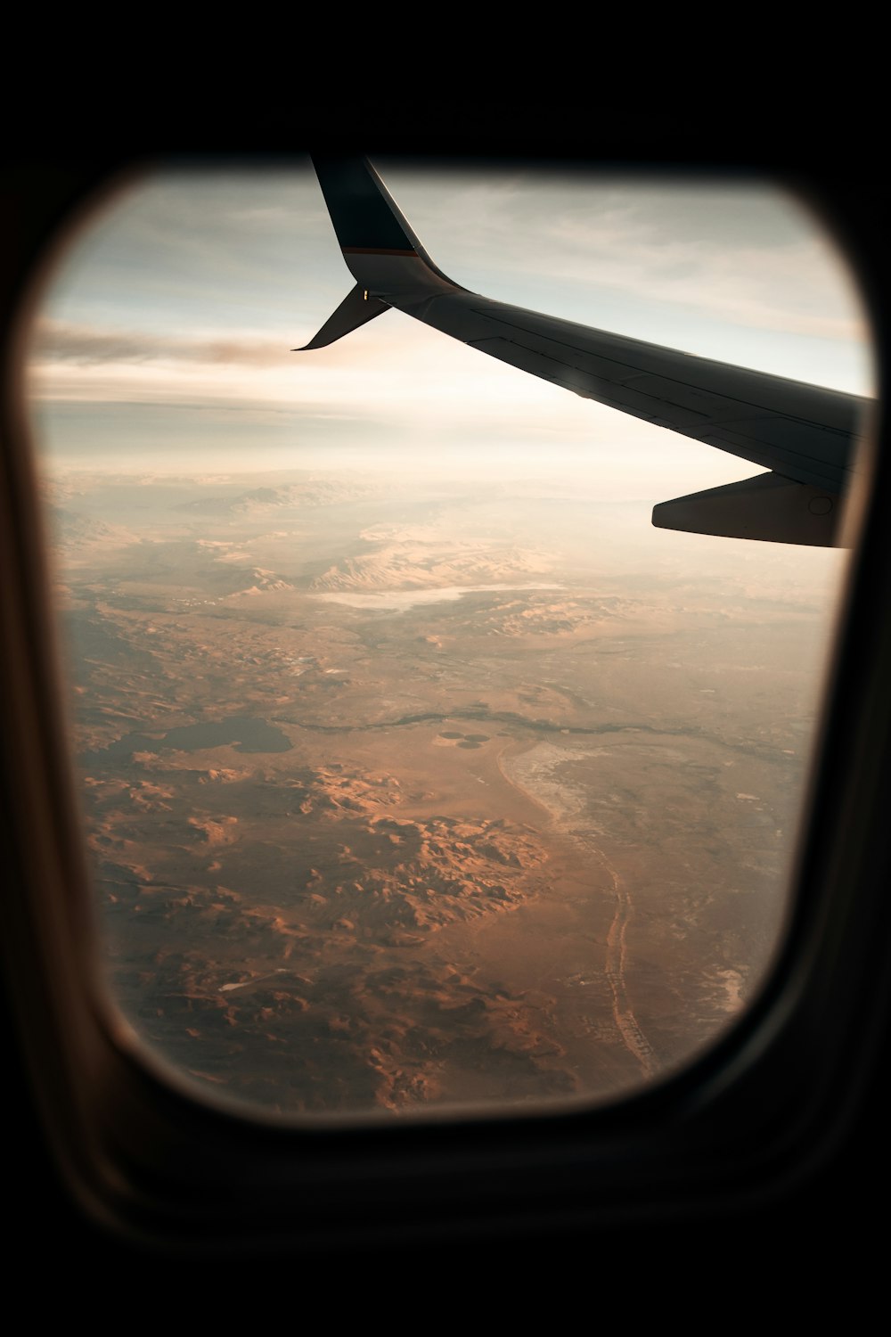 airplane window view of clouds during daytime