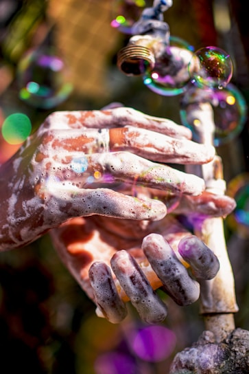 Foaming cleanser being applied to hands with natural light