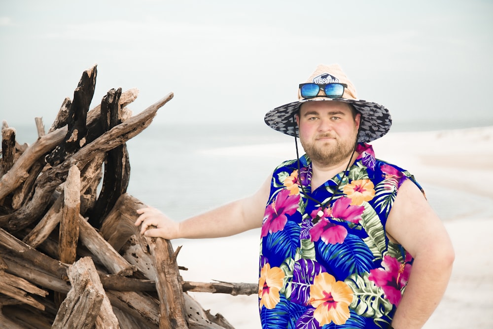 woman in blue and white floral sleeveless dress wearing brown straw hat standing beside brown wood