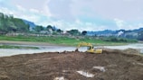 Excavator working on a hillside project in Ayacucho region